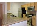 Kitchen with granite countertops and stainless steel appliances at 870 Regatta Bay Dr # 4-103, Orange City, FL 32763