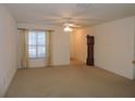 Bright living room with neutral carpeting and large window at 870 Regatta Bay Dr # 4-103, Orange City, FL 32763