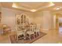 Formal dining room with glass-top table and antique china cabinet at 8755 The Esplanade # 103, Orlando, FL 32836