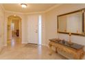 Elegant entryway with a marble-top console table and mirror at 8755 The Esplanade # 103, Orlando, FL 32836