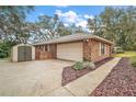 Attached garage with additional storage shed at 9908 Fairway Cir, Leesburg, FL 34788