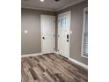 Bright entryway with wood-look flooring and neutral walls at 102 Aberdeen Dr, Fern Park, FL 32730