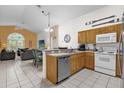 Open kitchen with stainless steel appliances and wood cabinets at 1037 Balmoral Dr, Davenport, FL 33896