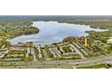 Aerial view showing property location near a lake and main road at 1158 Calle Del Norte # D, Casselberry, FL 32707