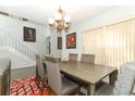 Dining room with a decorative chandelier and access to the stairwell at 1369 Black Willow Trl, Altamonte Springs, FL 32714