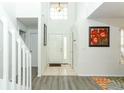 Bright foyer with tile floors transitioning to wood and high ceilings at 1369 Black Willow Trl, Altamonte Springs, FL 32714