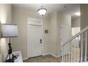 Bright entryway with tiled floors and staircase leading upstairs at 1498 Moon Valley Dr, Davenport, FL 33896