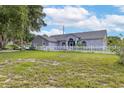 Single story home exterior showcasing a large grassy lot at 17901 Coralwood Ln, Groveland, FL 34736