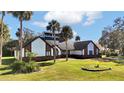 Expansive single-Gathering home boasting a lush green lawn and unique architecture with white siding and brick details at 2305 Leeward Cv, Kissimmee, FL 34746