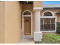 Inviting entryway with a decorative wreath and arched window at 24728 Calusa Blvd, Eustis, FL 32736