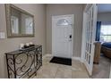 Bright entryway with tile flooring, a decorative console table, and French doors at 2518 Hayden Valley St, Apopka, FL 32703