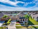 Aerial view of a landscaped home in a residential neighborhood under a blue sky at 2570 Marshfield Preserve Way, Kissimmee, FL 34746