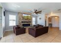 Living room showcases a stunning stone wall, electric fireplace, and cozy furniture at 2570 Marshfield Preserve Way, Kissimmee, FL 34746