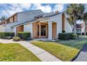 Inviting exterior of a two-story townhome with a landscaped lawn and walkway at 3002 Clubview Dr, Orlando, FL 32822