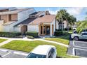 Inviting townhome with a neat front yard, mature palm trees, and convenient parking at 3002 Clubview Dr, Orlando, FL 32822