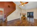 Bright living room features vaulted ceilings, fireplace, hardwood floors, and sliding glass doors to outdoor space at 3002 Clubview Dr, Orlando, FL 32822
