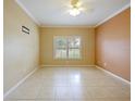 Neutral bedroom with large window, tile floors, ceiling fan and wall-mount for television at 337 Fern Lake Dr, Orlando, FL 32825