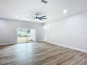 Bright living room with sliding glass doors and wood-look floors at 413 Ruby Ave, Deland, FL 32724