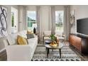 Living room with white couch and gray accent chairs at 4569 Cross Prairie Pkwy, St Cloud, FL 34772