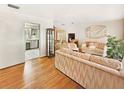 Living room with hardwood floors and neutral colored sofas at 5240 N Powers Dr, Orlando, FL 32818