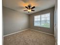 Well-lit bedroom featuring neutral wall paint and plush carpeting at 617 Finn Ave, Auburndale, FL 33823