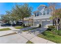 Attractive gray townhomes with two-car garages and neatly landscaped yards at 622 Glastonbury Dr, Orlando, FL 32825