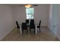 Bright dining room features a glass-top table with six black chairs at 7852 Murcott Cir, Orlando, FL 32835