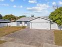 Charming single-story home with a white garage door and landscaped lawn at 7852 Murcott Cir, Orlando, FL 32835