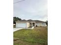 Tan house with white garage door and columns at 975 Gascony Ct, Kissimmee, FL 34759