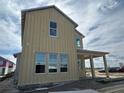 Unfinished two-story home, tan siding, many windows at 9828 Peebles St, Orlando, FL 32827