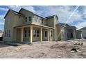 Two-story home under construction, tan siding, large front porch at 9828 Peebles St, Orlando, FL 32827