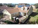 One-story house with solar panels on the roof and a courtyard at 107 Cupania Ct, Groveland, FL 34736