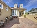 Brick paved courtyard with seating area and potted plants at 107 Cupania Ct, Groveland, FL 34736