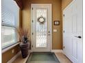 Bright entryway with a glass front door and decorative vase at 107 Cupania Ct, Groveland, FL 34736