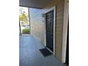 Private condo entry with a black door and mat at 1071 S Hiawassee Rd # 1213, Orlando, FL 32835