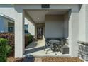 Welcoming front porch featuring an outdoor seating area, stone accents, and a well-kept garden space at 11526 Comic Aly, Orlando, FL 32832