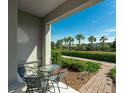 Outdoor seating area on the front porch shows a paver walkway and the green, lush landscaping at 11526 Comic Aly, Orlando, FL 32832