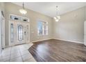 Bright and airy foyer with hardwood and tile flooring at 116 Whispering Pines Way, Davenport, FL 33837