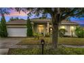 House exterior at dusk, showcasing the home's curb appeal at 116 Whispering Pines Way, Davenport, FL 33837