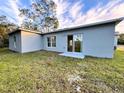 Newly built home with sliding glass doors leading to a grassy backyard at 1211 Baltic Dr Dr, Poinciana, FL 34759