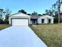 Newly constructed one-story home with a white garage door and gray exterior at 1211 Baltic Dr Dr, Poinciana, FL 34759