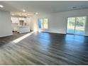 Open-concept living area with modern flooring and kitchen access at 1212 Baltic Dr Way, Poinciana, FL 34759