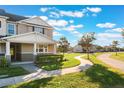 Two-story townhome with front walkway, landscaping, and a curved pathway at 13715 Bressler Aly, Windermere, FL 34786