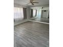 Spacious living room with large mirror and light grey tile floors at 1414 Rolling Green Dr, Apopka, FL 32703