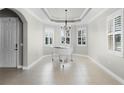 Bright living room featuring a white piano and elegant chandelier at 15925 St Clair St, Clermont, FL 34714