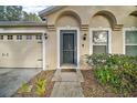 Front door entrance with a small walkway and landscaping at 1603 S Mary St, Eustis, FL 32726