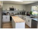 Modern kitchen featuring stainless steel appliances, island and white cabinets at 1705 Underwood Ave, St Cloud, FL 34771