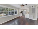 Bright dining area with hardwood floors and a view into the kitchen with stainless appliances at 2106 Cordova Dr, Sanford, FL 32771