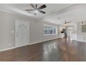 Open living space with hardwood floors, ceiling fan, and view into the kitchen at 2106 Cordova Dr, Sanford, FL 32771