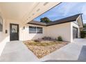 Inviting front entry with a charming stone pathway and landscaping at 2247 King Edwards Ct, Winter Park, FL 32792